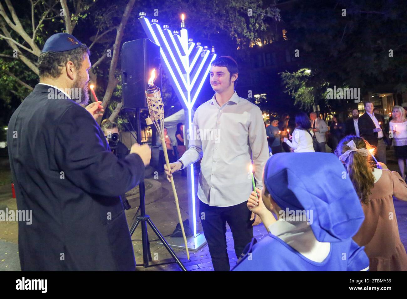 Chabad Rabbi Shmuel Tiechtel and Shalom Kapuler light the tikitorch