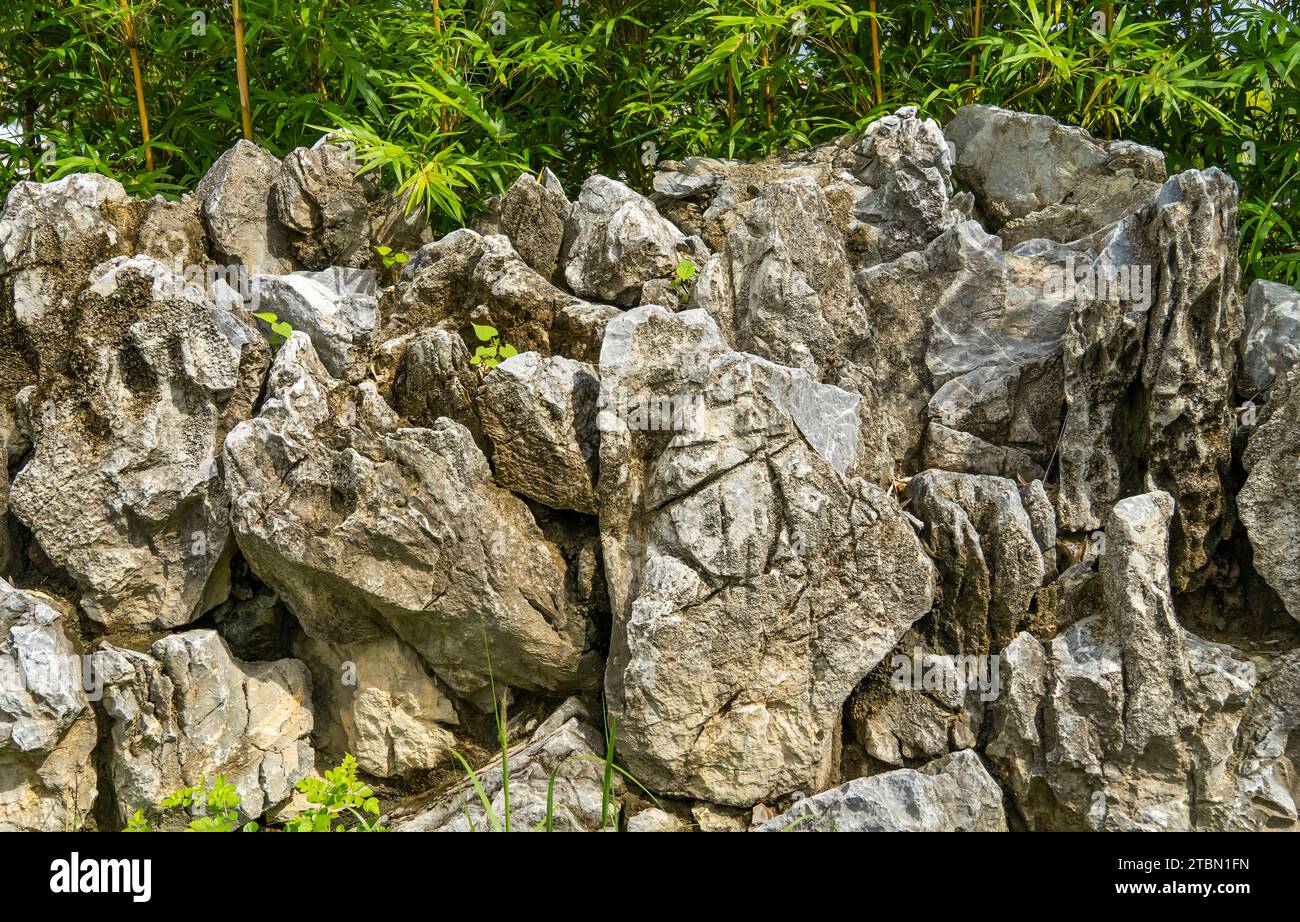 wall of large limestone boulders in a rock garden Stock Photo - Alamy