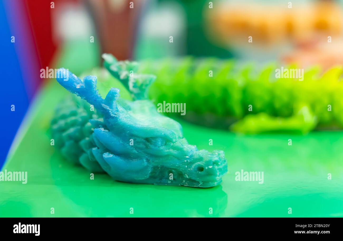 3D printer printing dragon head figure close-up. Stock Photo
