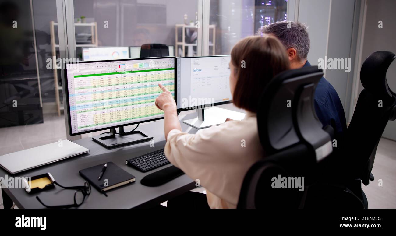 Working Analyst at Desktop Computer with Spreadsheet Spreadsheets Stock Photo