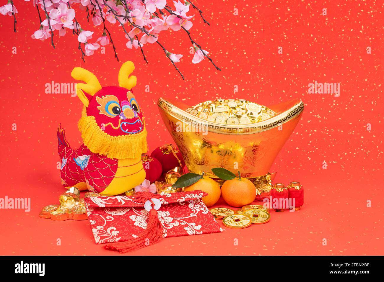 Tradition Chinese cloth doll dragon,2024 is year of the dragon,Chinese golden characters  golden coin Translation:good luck for money Stock Photo