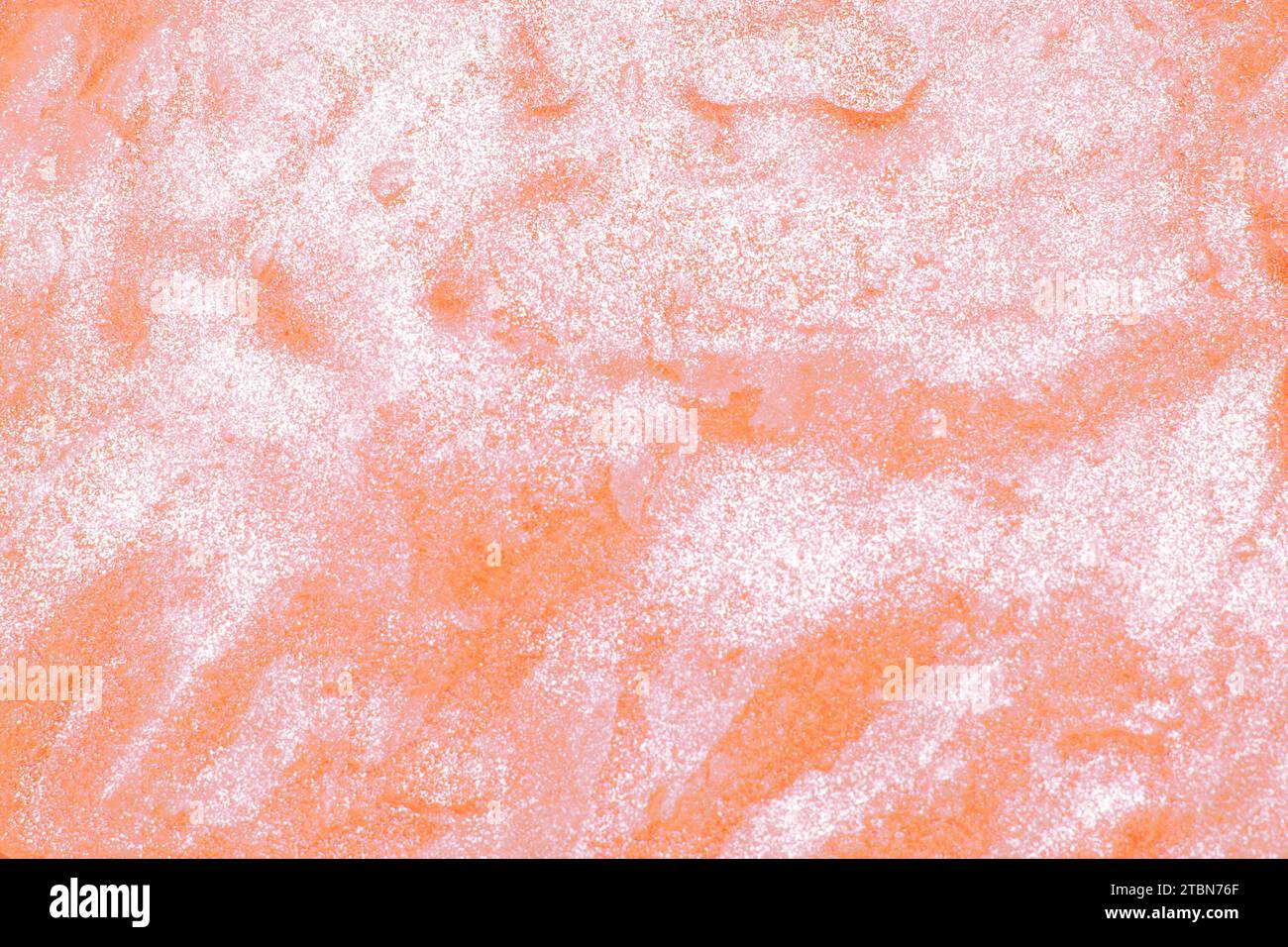 Abstract Peach Fuzz background with texture of slime or other liquid substance. Squishy slimy texture in close up detail. Color of the year 2024 Stock Photo
