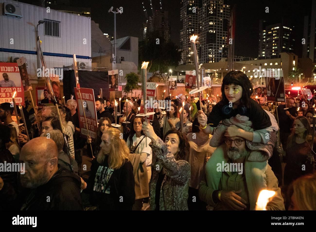 Tel Aviv, Israel. 7th Dec, 2023. People carry lit candles during a