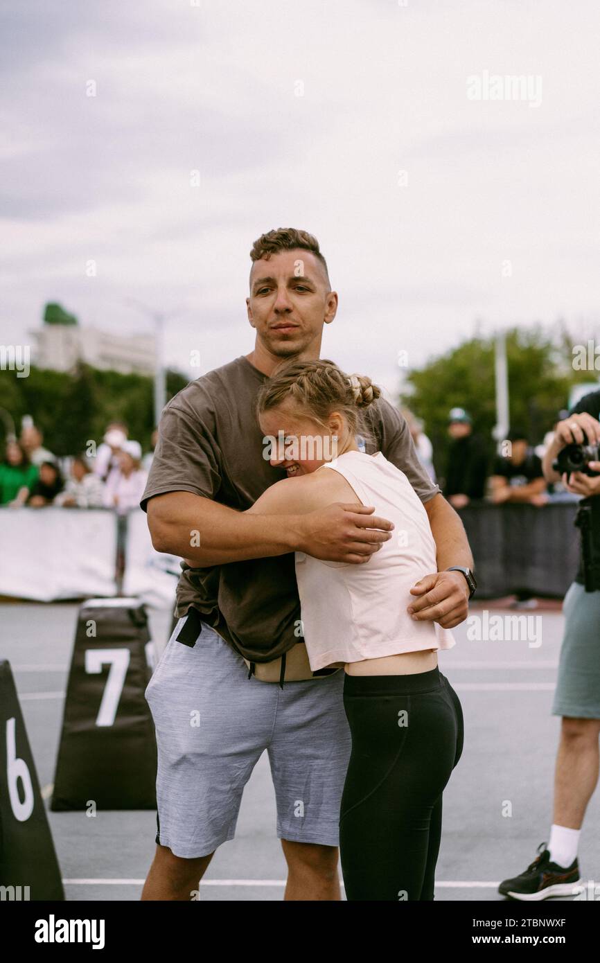 The athlete hugs coach, congratulating each other at the competition. Stock Photo
