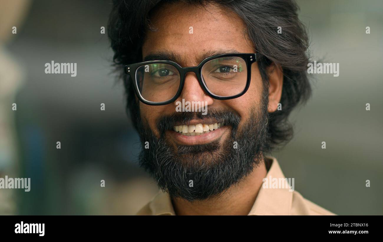 Close up portrait happy Indian bearded 30s businessman in eyeglasses male posing for camera. Handsome Arabian multiethnic man in glasses business Stock Photo