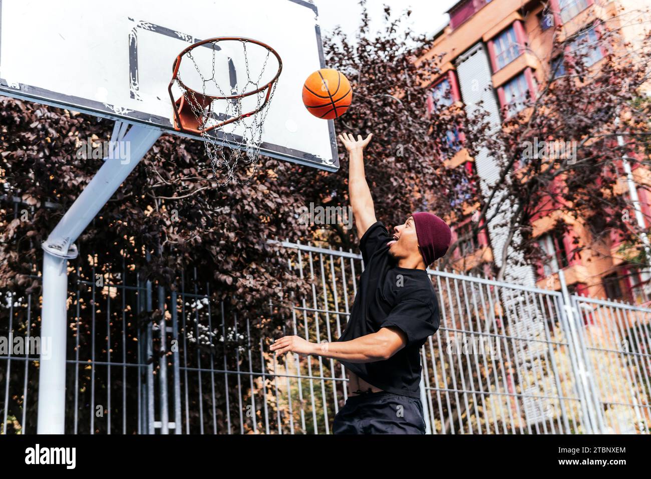 multiethnic boy shooting basket playing basketball Stock Photo
