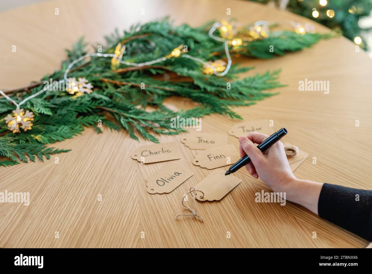 Handwriting names on holiday gift tags, some names filled Stock Photo
