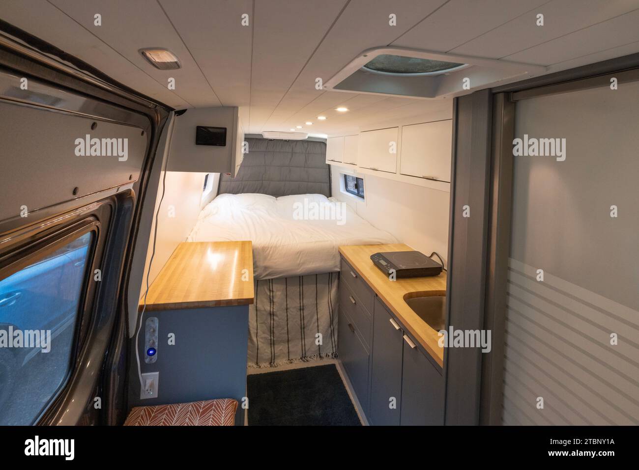Warm inviting interior of a converted camper van Stock Photo
