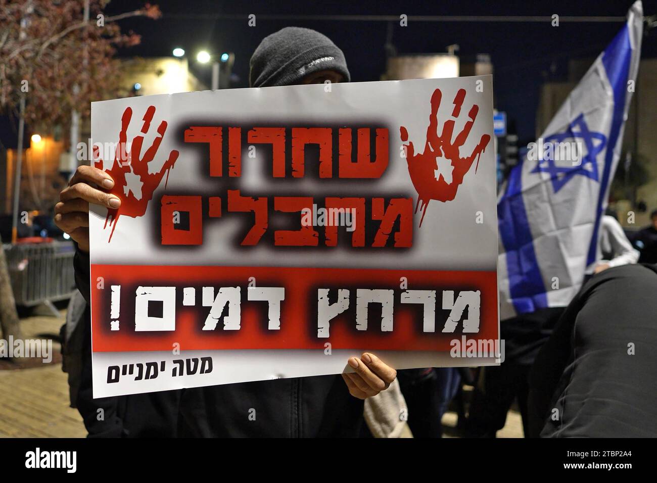 A right-wing activist holds a sign that reads 'Release of terrorists is bloodbath' during a protest dubbed the 'March of the Maccabees' outside Jerusalem Old City on December 7, 2023 in Jerusalem. The protest was organized to memorialize victims of the Israel-Hamas war, while also demanding that the entirety of Jerusalem, including the Temple Mount/Al-Aqsa Mosque compound, be placed under Jewish control. Stock Photo