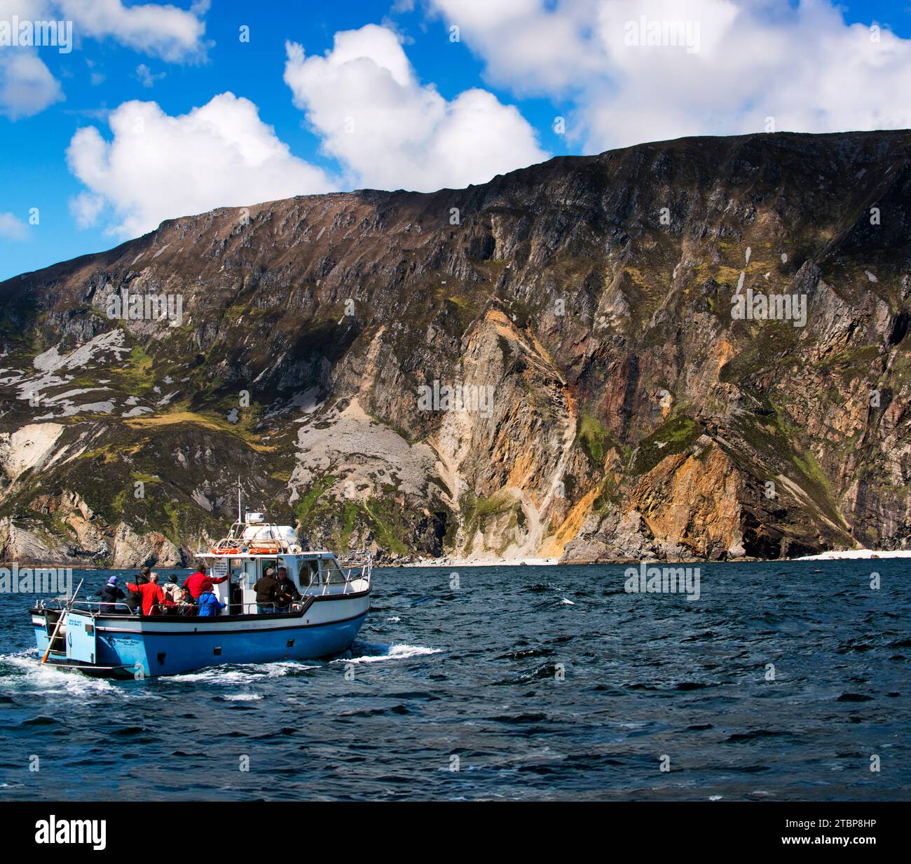 Tourist boat under the cliffs of Slieve League, Sliabh Liag,County Donegal, Ireland Stock Photo