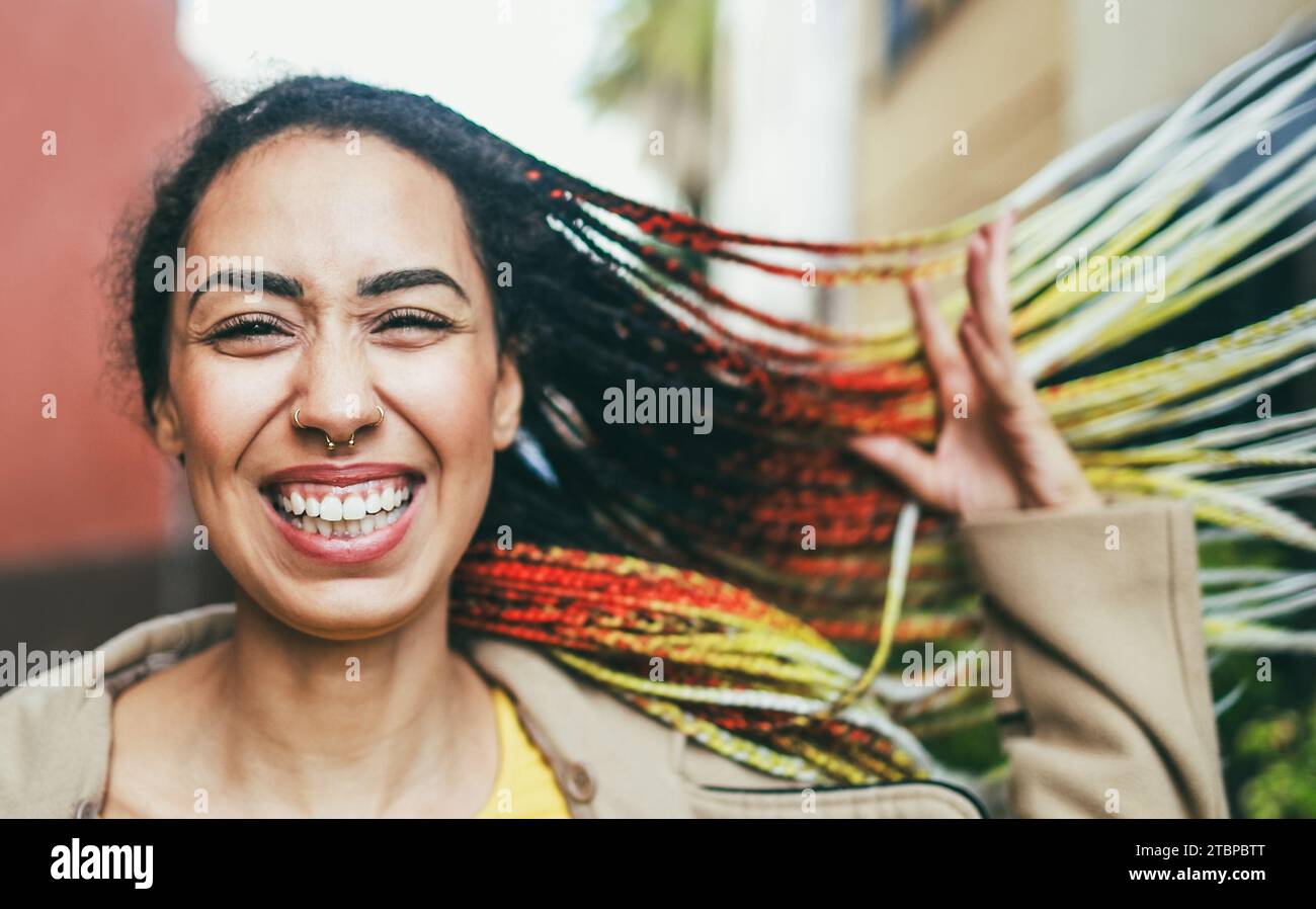 Mixed race girl smiling in front of camera during winter time - Fashion and trendy concept - Soft focus on nose Stock Photo
