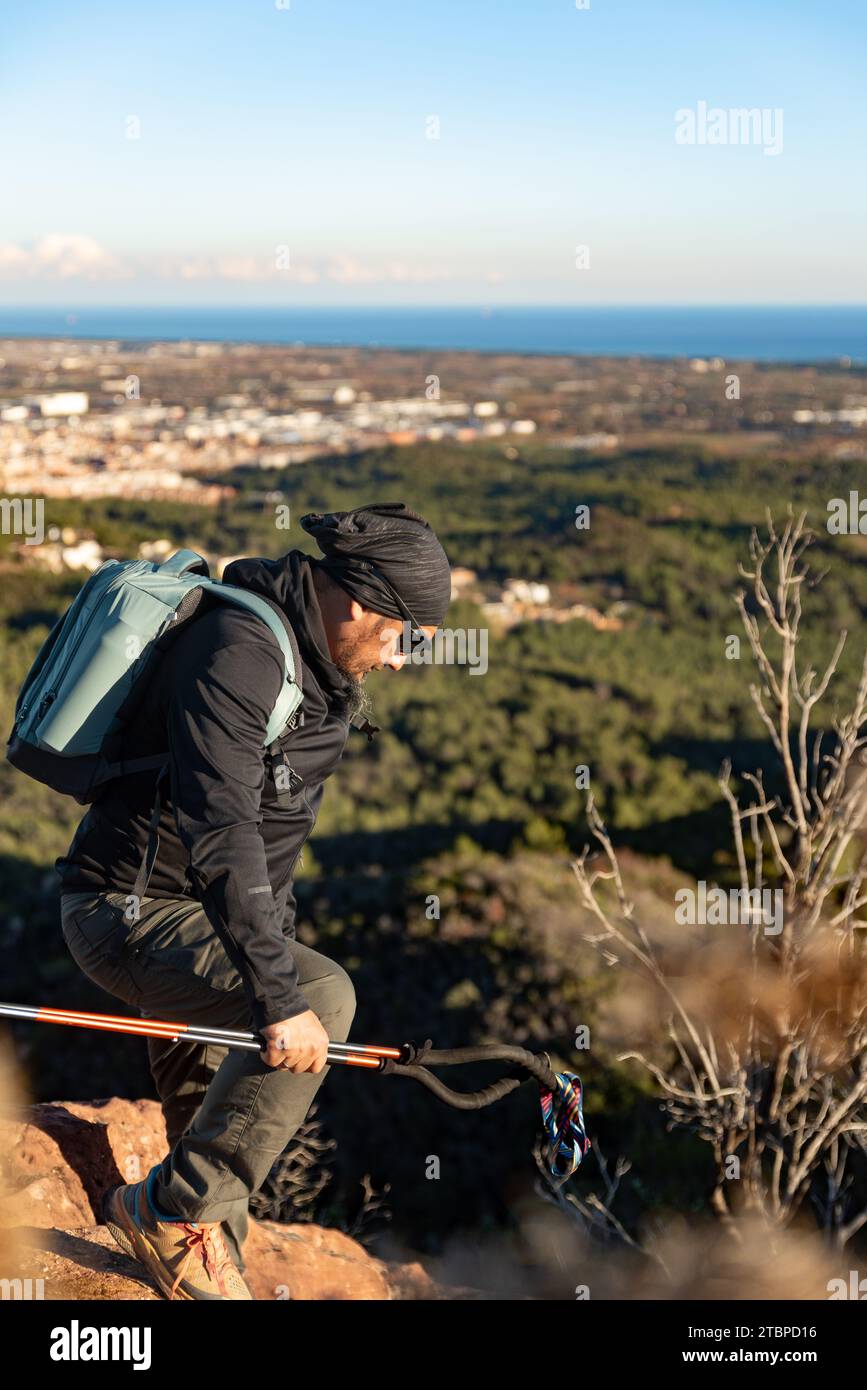 Man descends the mountain surrounded by the landscape of the Garraf Natural Park. Stock Photo