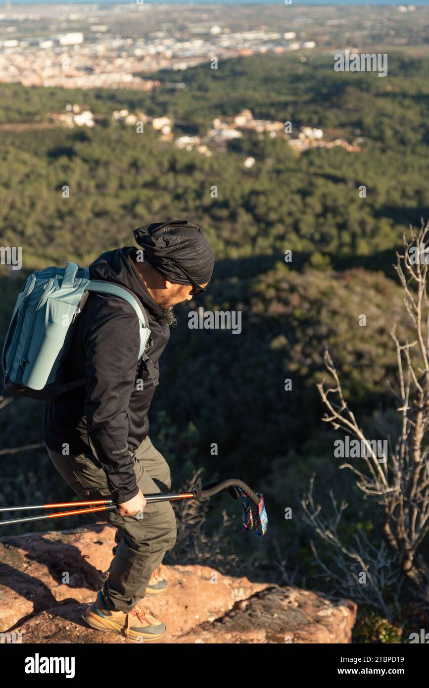 Man descends the mountain surrounded by the landscape of the Garraf Natural Park. Stock Photo
