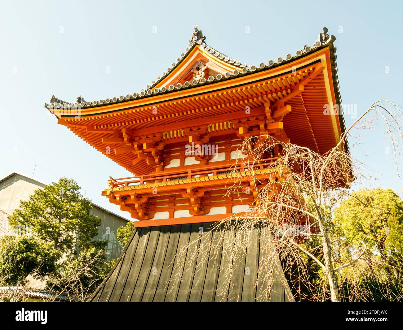 A contemporary highrise building stands prominently in an urban