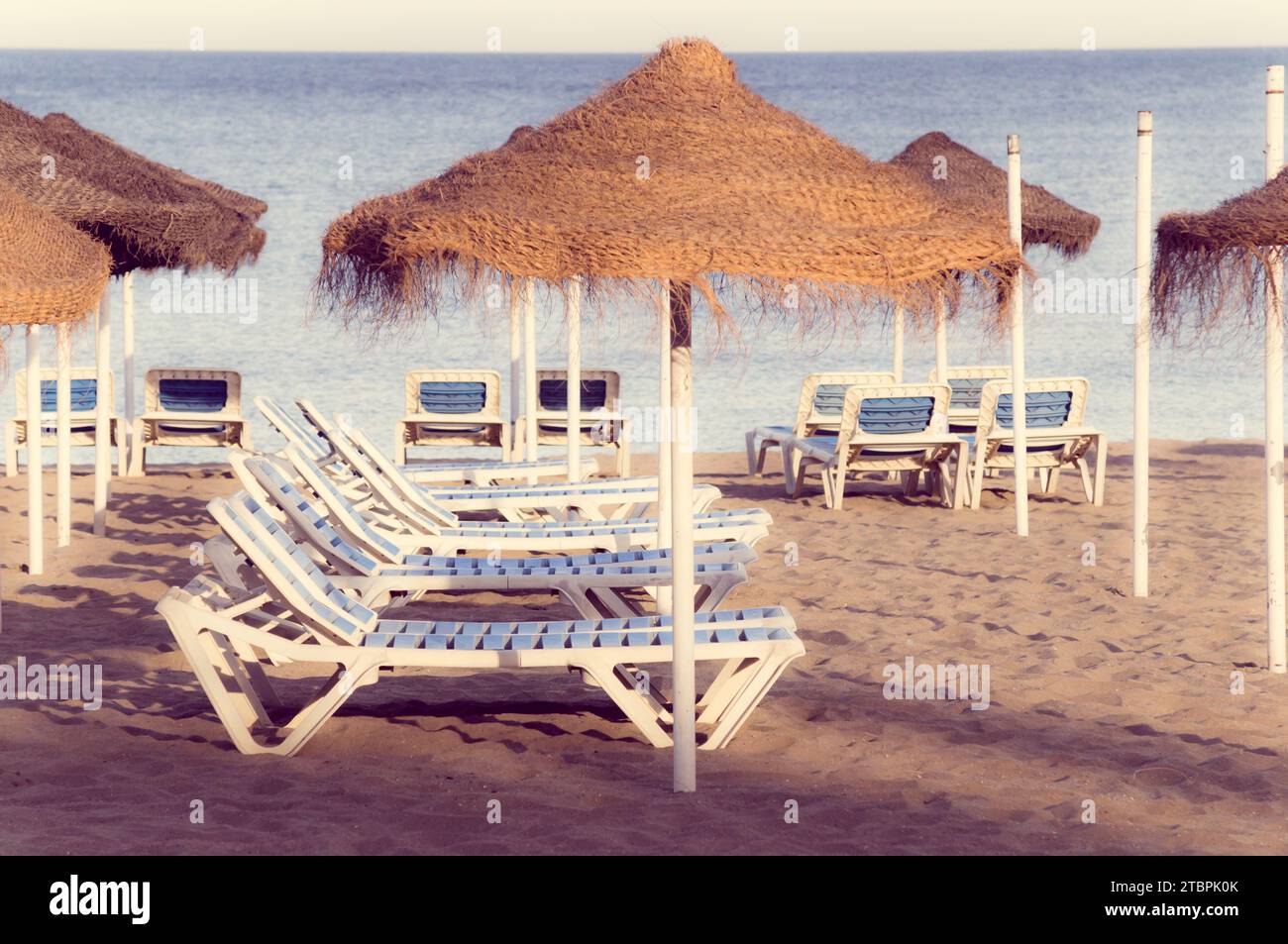 View of An idyllic seaside scene featuring two beach chairs and two large ...