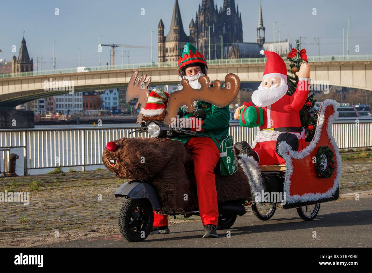 Santa Claus on a Vespa scooter decorated as a reindeer and sleigh, members of the Vespa scooter club RheinSchalter Koeln dressed as Santas gather on D Stock Photo