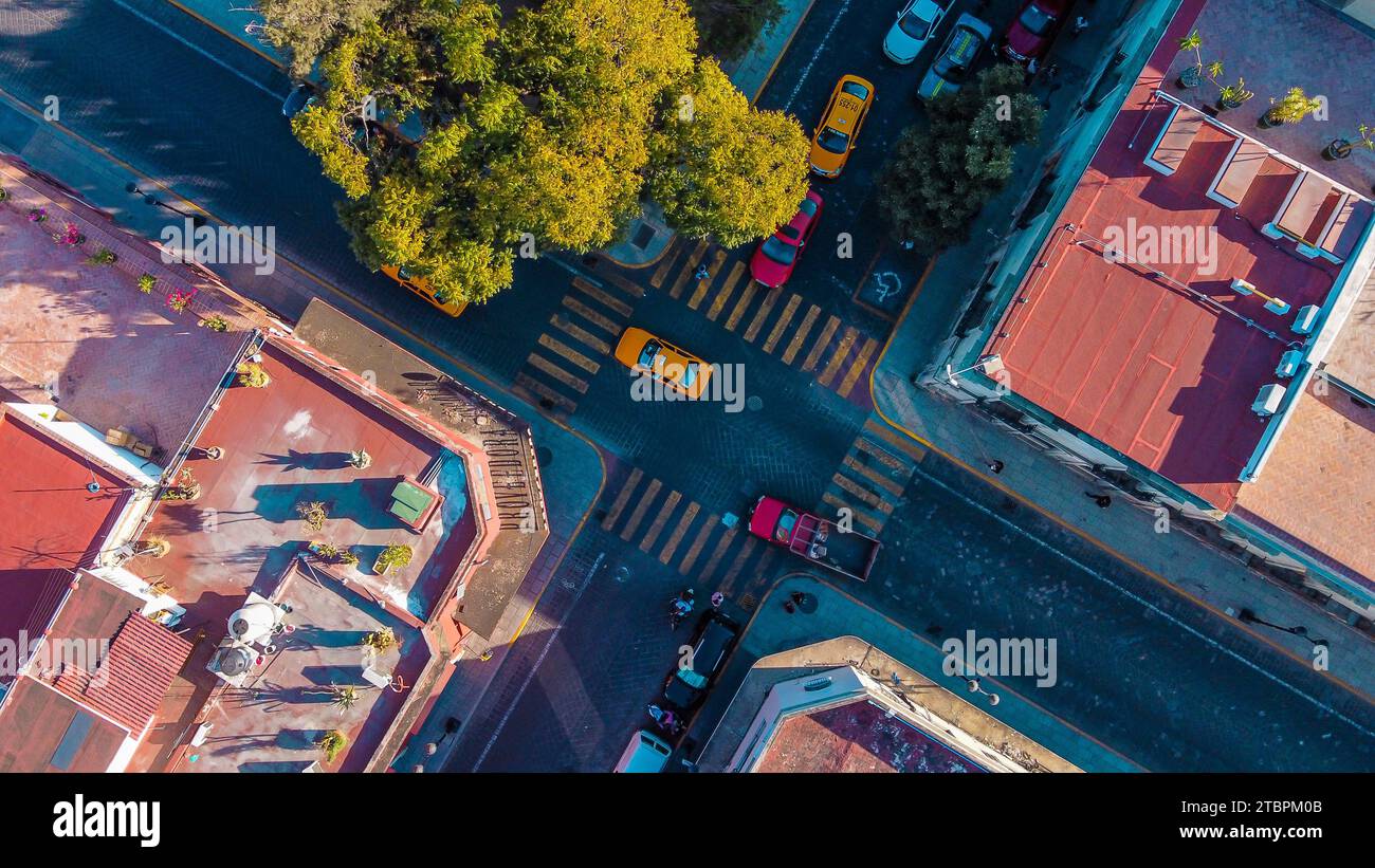 An aerial view of a street corner with several cars parked along the side Stock Photo
