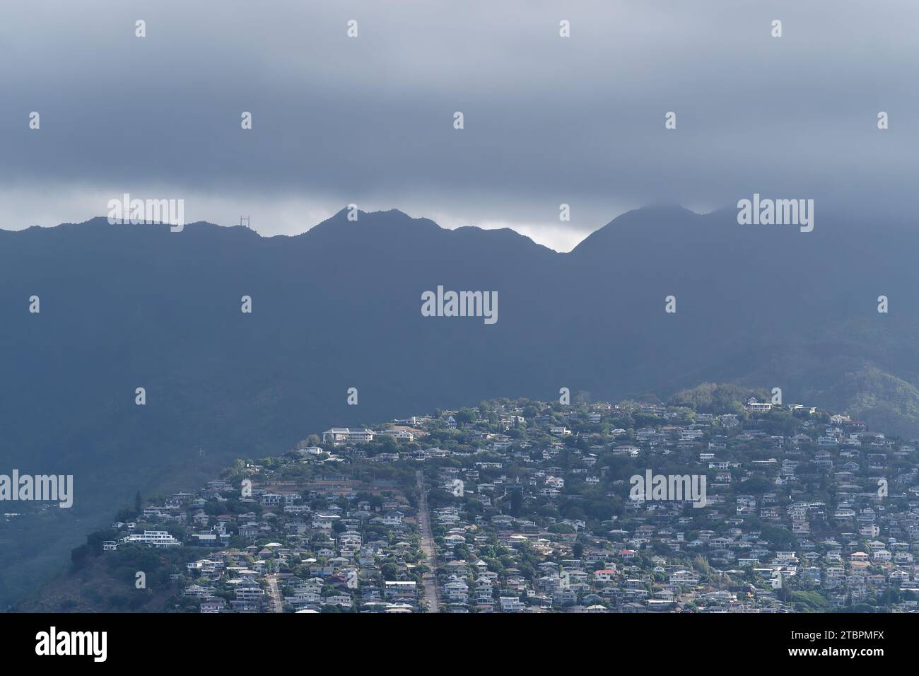 Aerial view of a picturesque small mountain village nestled in the foothills of the surrounding rugged mountainscape Stock Photo