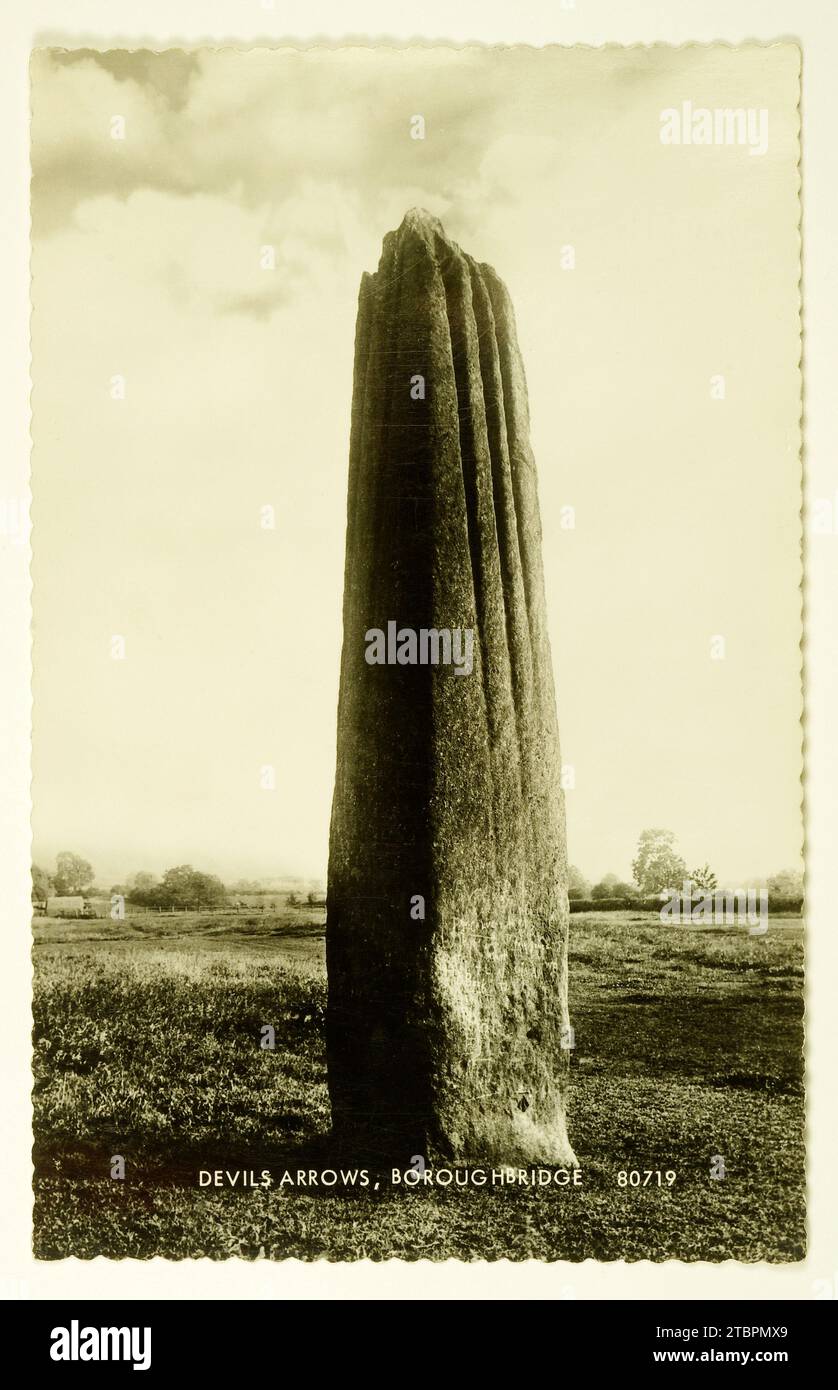 Devil's Arrows, Boroughbridge. - OLD POSTCARD - Old postcard showing the largest stone nearest to the road, now surrounded by a fence and crowded by t Stock Photo