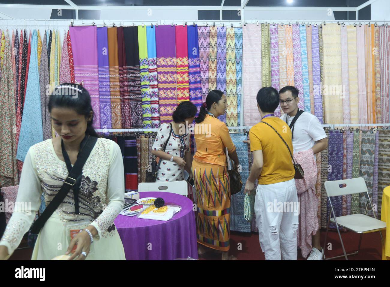 Yangon, Myanmar. 8th Dec, 2023. People visit an exhibition booth during