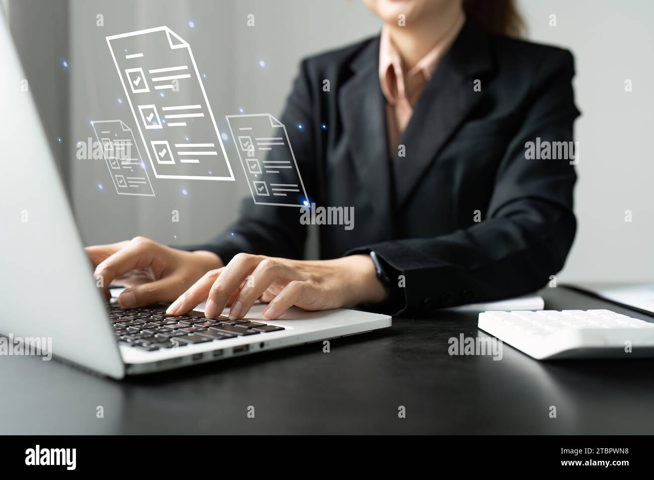 Businesswoman working on a laptop computer to document management ...