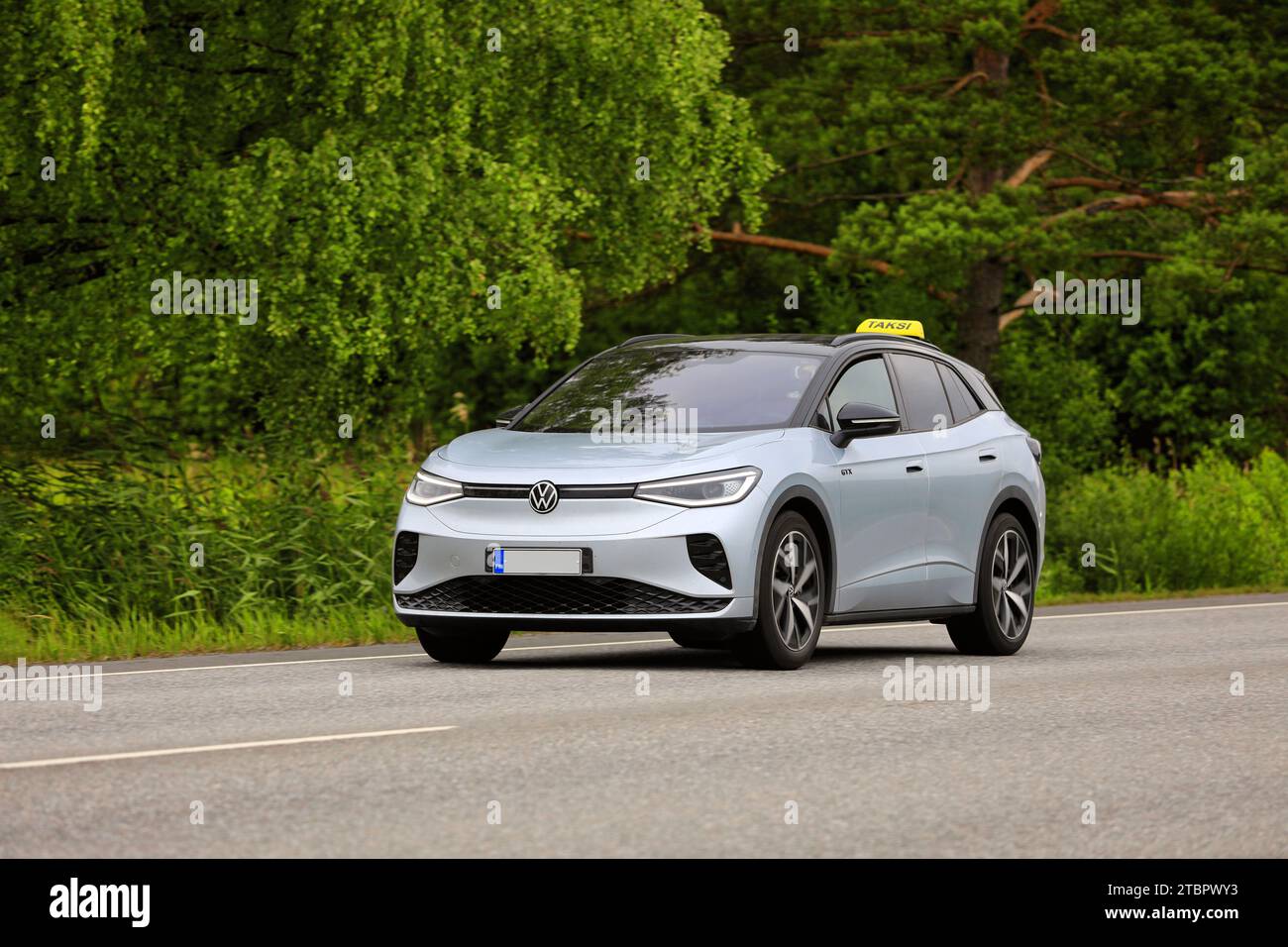 Silver Volkswagen ID.4 GTX 4-Motion taxi electric SUV car year 2023 on road in summer sunlight. Salo, Finland. July 6, 2023 Stock Photo