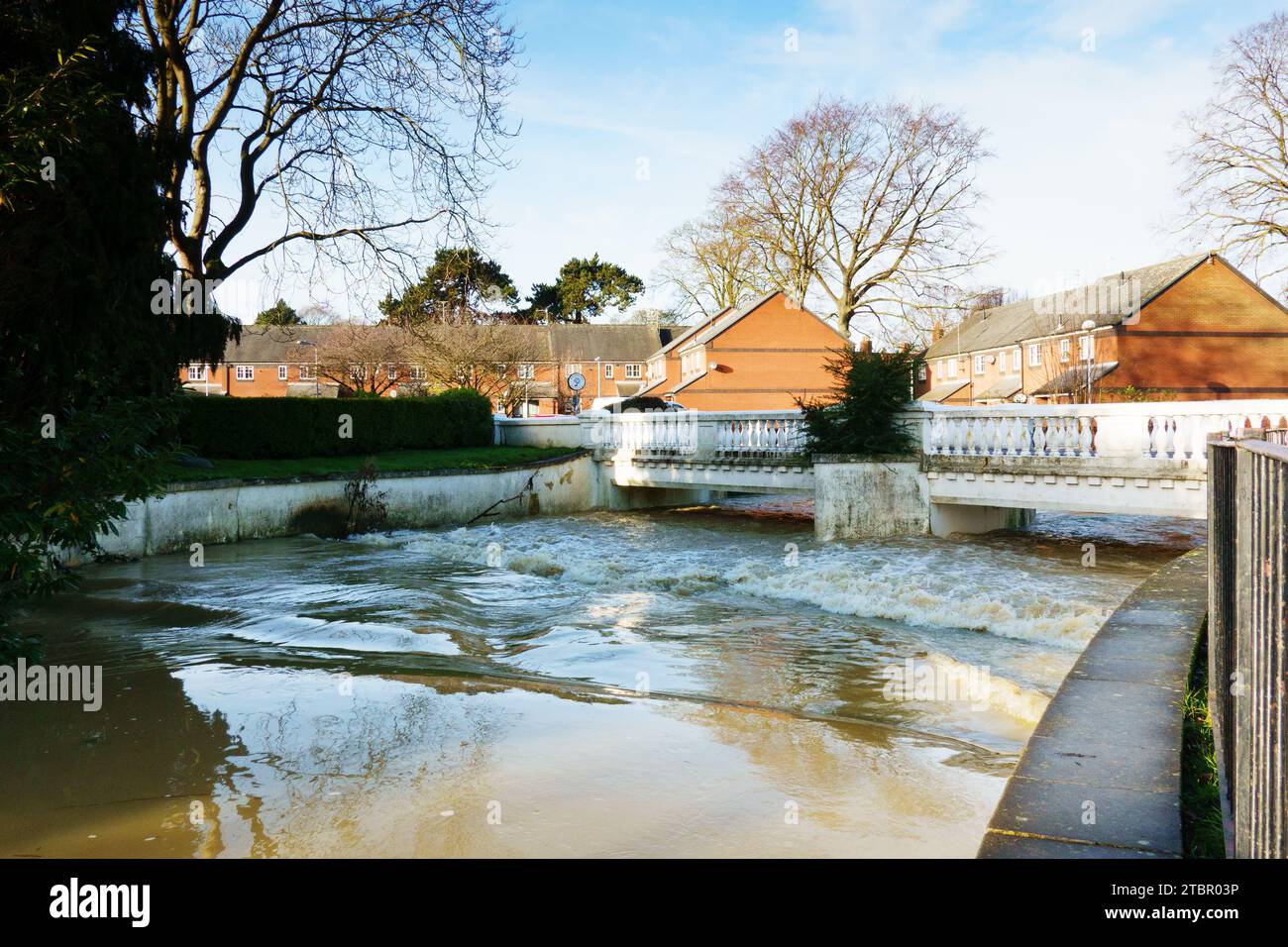 River Witham in flood high water flows under the White Bridge at Wyndham Park, Grantham, Lincolnshire, England Stock Photo