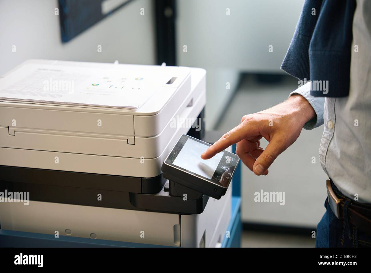 Employee uses office equipment to work with documents Stock Photo
