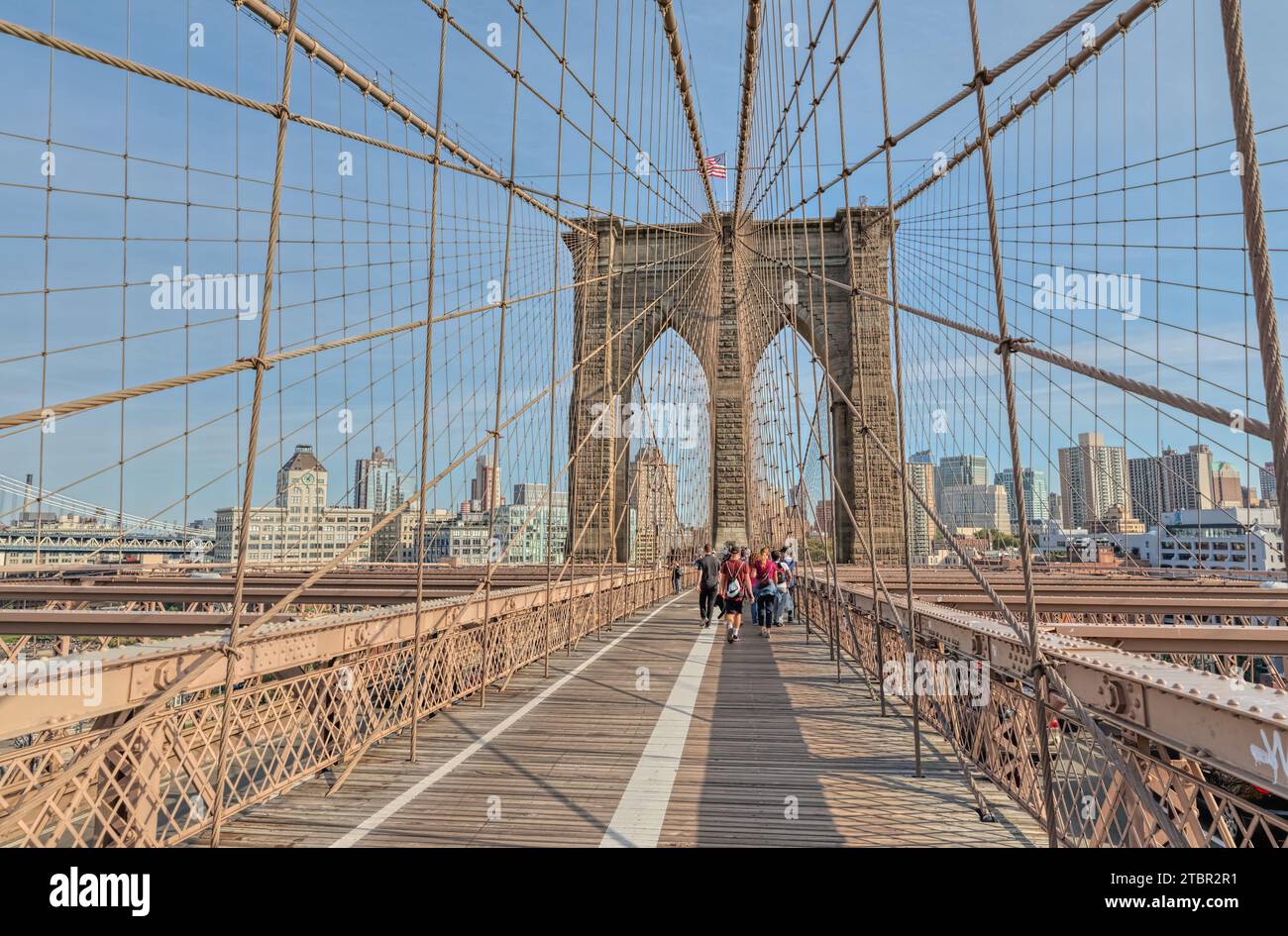 People are crossing the Brooklyn Bridge in New York Stock Photo