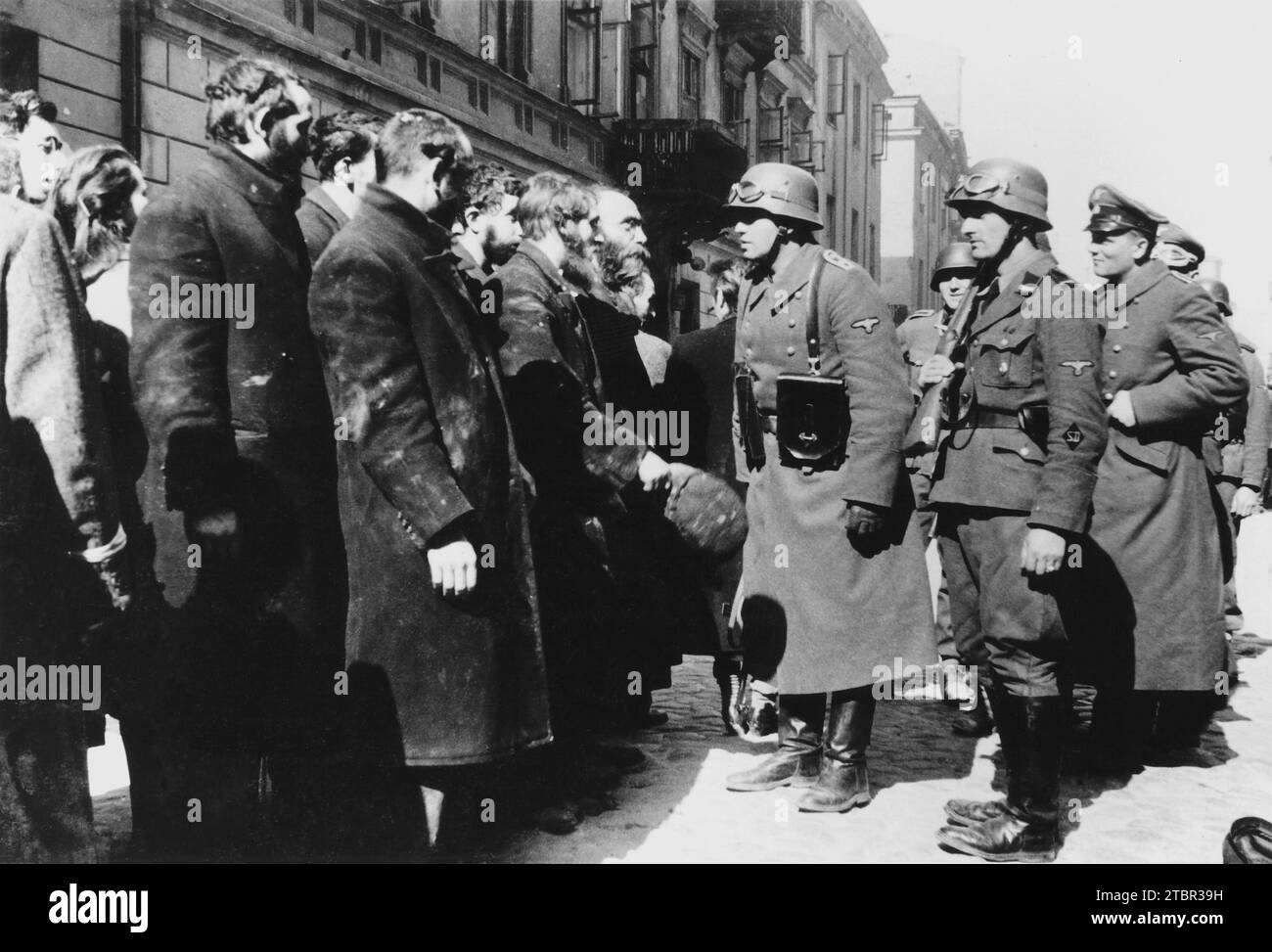 Warsaw Ghetto Uprising - Interrogation by SS Sergeant (Oberscharführer). Between 19 April - 16 May 1943. Photo from Nowolipie Street.  Bearded man sta Stock Photo