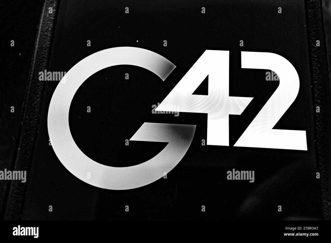 Abu Dhabi, United Arab Emirates. 6th Dec, 2023. The G42 logo.G42 is a technology company based in the Middle East with a focus on artificial intelligence, cloud computing, and data analytics. It has been involved in various projects, including initiatives related to healthcare, defense, and smart cities. The company was founded by Peng Xiao, who renounced his US Citizenship in favor of Emirati citizenship and has been subjected to a report by the New York Times alleging business ties to China. AI, business, tech, startup, GCC, Gulf business. (Credit Image: © Taidgh Barron/ZUMA Press Wire) Stock Photo
