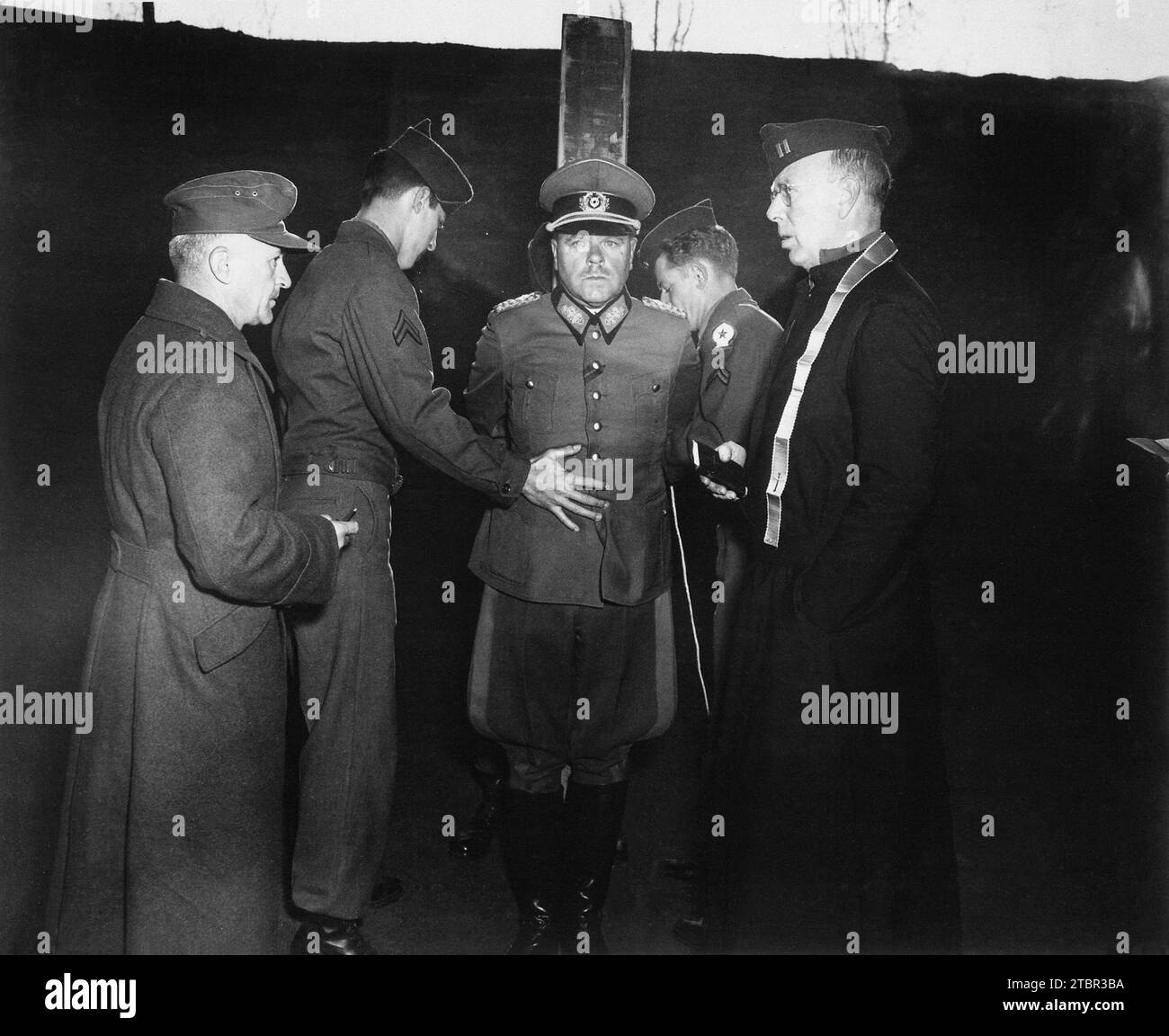 German General Anton Dostler is tied to a stake before his execution by a firing squad in the Aversa stockade. The General was convicted and sentenced Stock Photo
