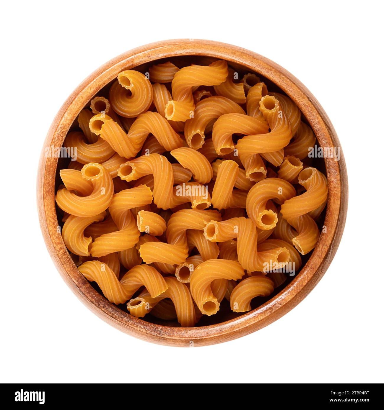 Cellentani or also cavatappi pasta in a wooden bowl. Corkscrew shaped gluten free pasta scored with lines or ridges on the surface. Stock Photo