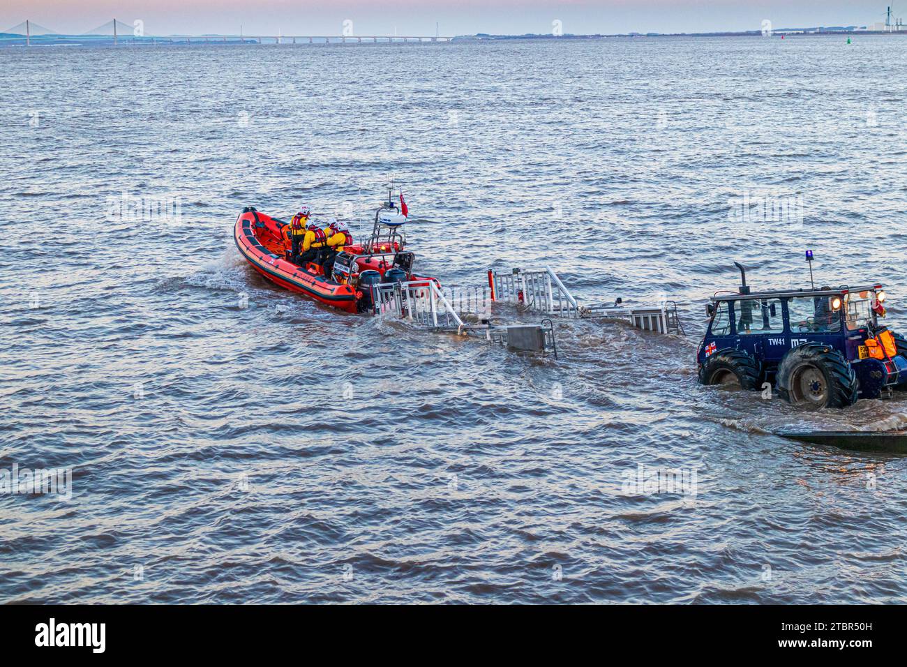 Launching RNLI B class Atlantic 85 inshore lifeboat 'My Lady Anne' at Portishead, North Somerset, England UK for a rescue shout at dusk on 24.11.2023 Stock Photo