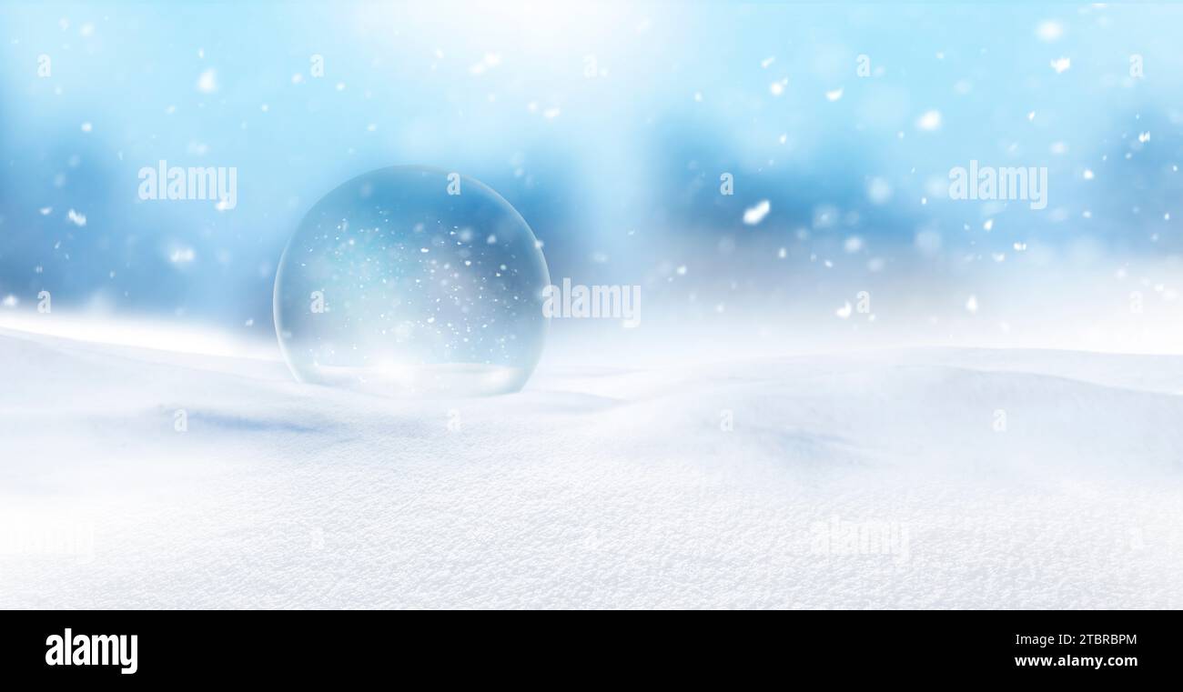 Glass ball with snowflakes in a blanket of snow Stock Photo