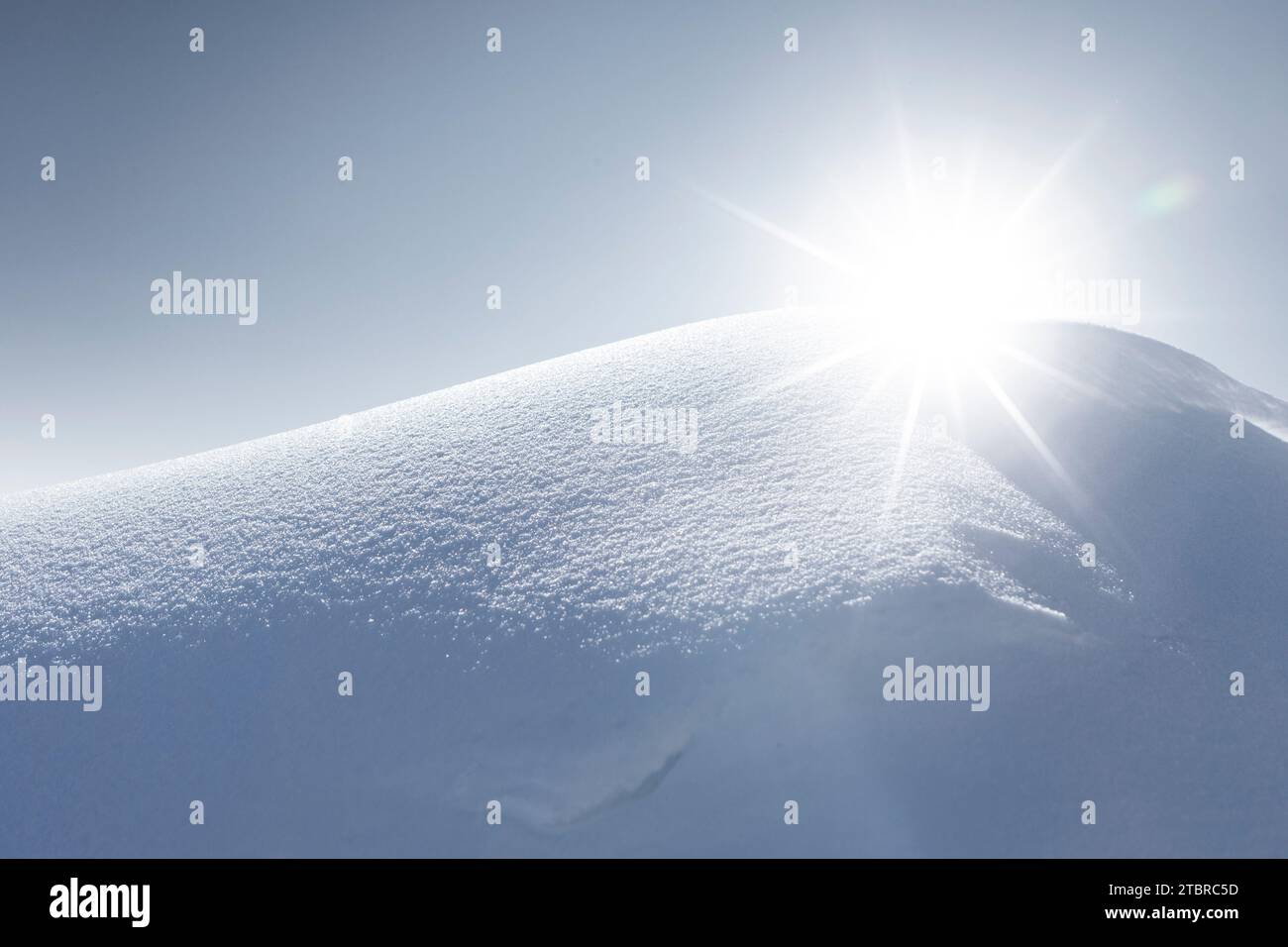 Sunbeam behind a snowdrift Close-up Stock Photo