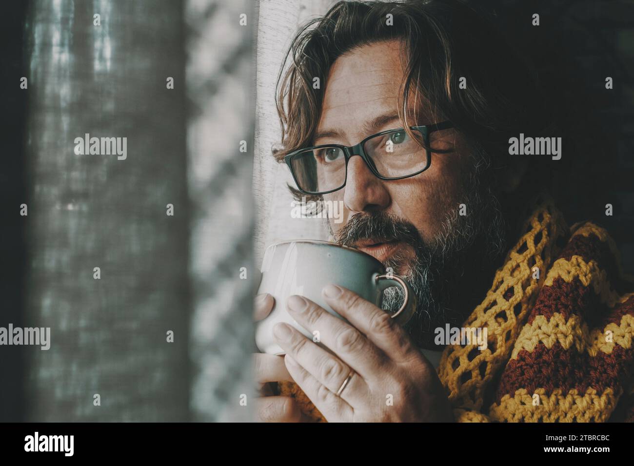 Side portrait of unhealthy man unhappy at home drinking medicine or