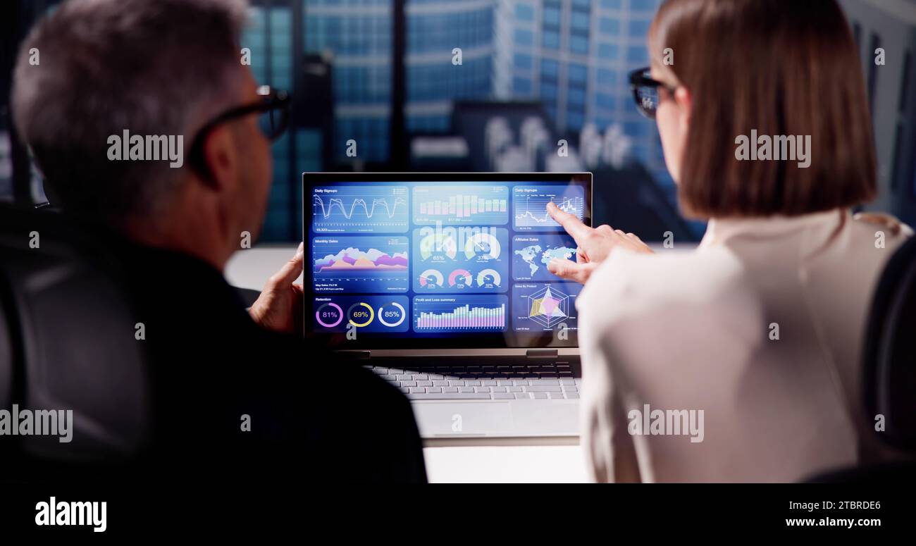Analyzing KPIs and Report with Laptop's Graphs on Dashboard Stock Photo