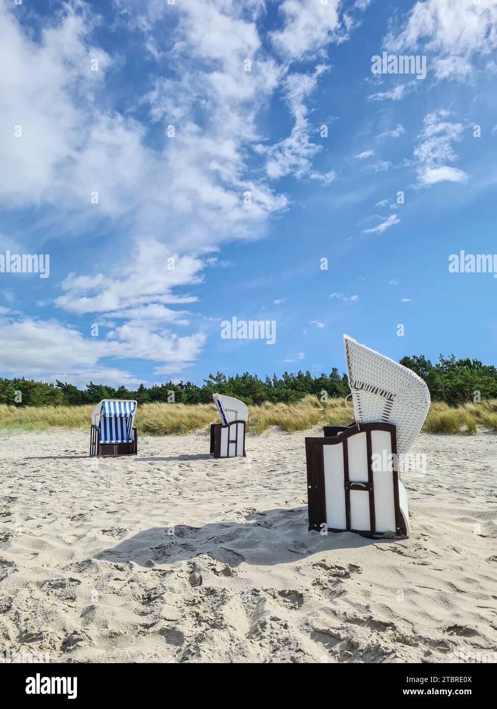 Blue sky with white fair weather clouds, sandy beach in Prerow on the