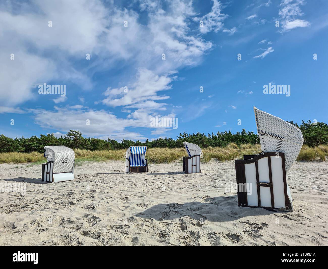 Blue sky with white fair weather clouds and beach chairs on sandy beach in Prerow, Baltic Sea, Fischland-Darß-Zingst peninsula, Mecklenburg-Western Pomerania, Germany Stock Photo