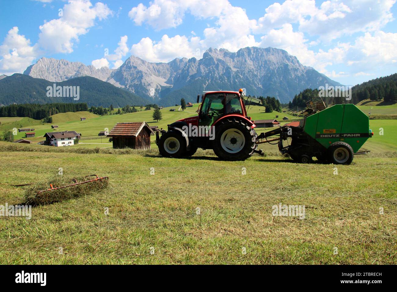 Lindner GeoTrac 73, 3300 cm³, 3 cylinders,, year 2009, tractor harvesting hay with Deutz-Fahr round baler, Germany, Bavaria, Upper Bavaria, Werdenfels Stock Photo