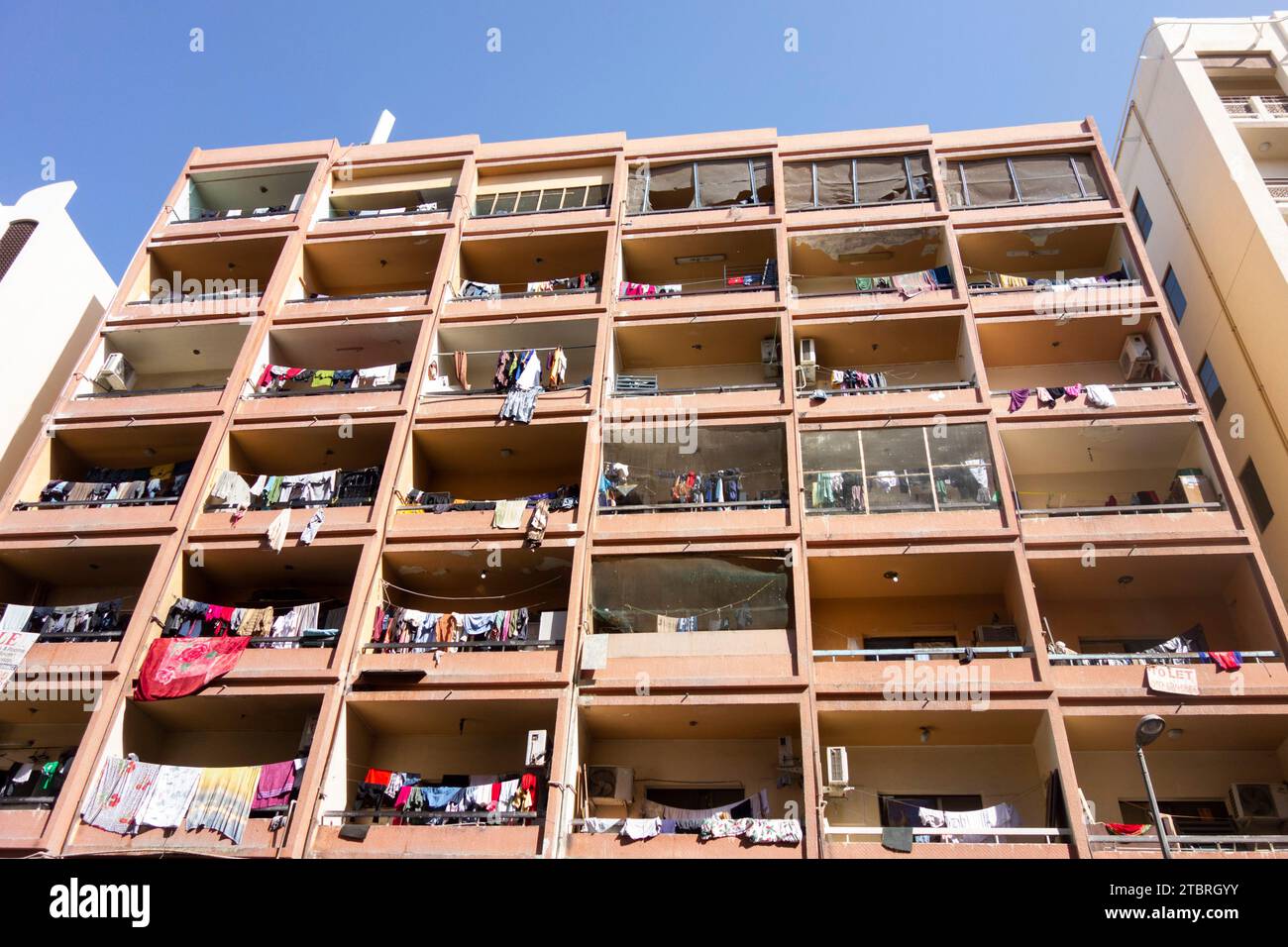Washing drying on the balconies of an apartment building in Bur Dubai, Dubai, UAE. Stock Photo