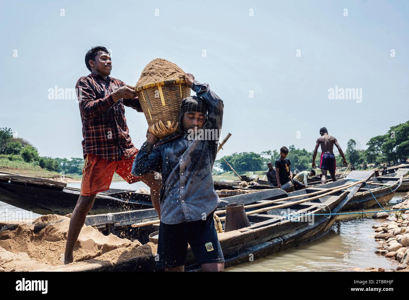 Men working at a high-quality sand collecting site, for the construction industry of the country. Lalakhal, near Jaflong, Sylhet Bangladesh Stock Photo