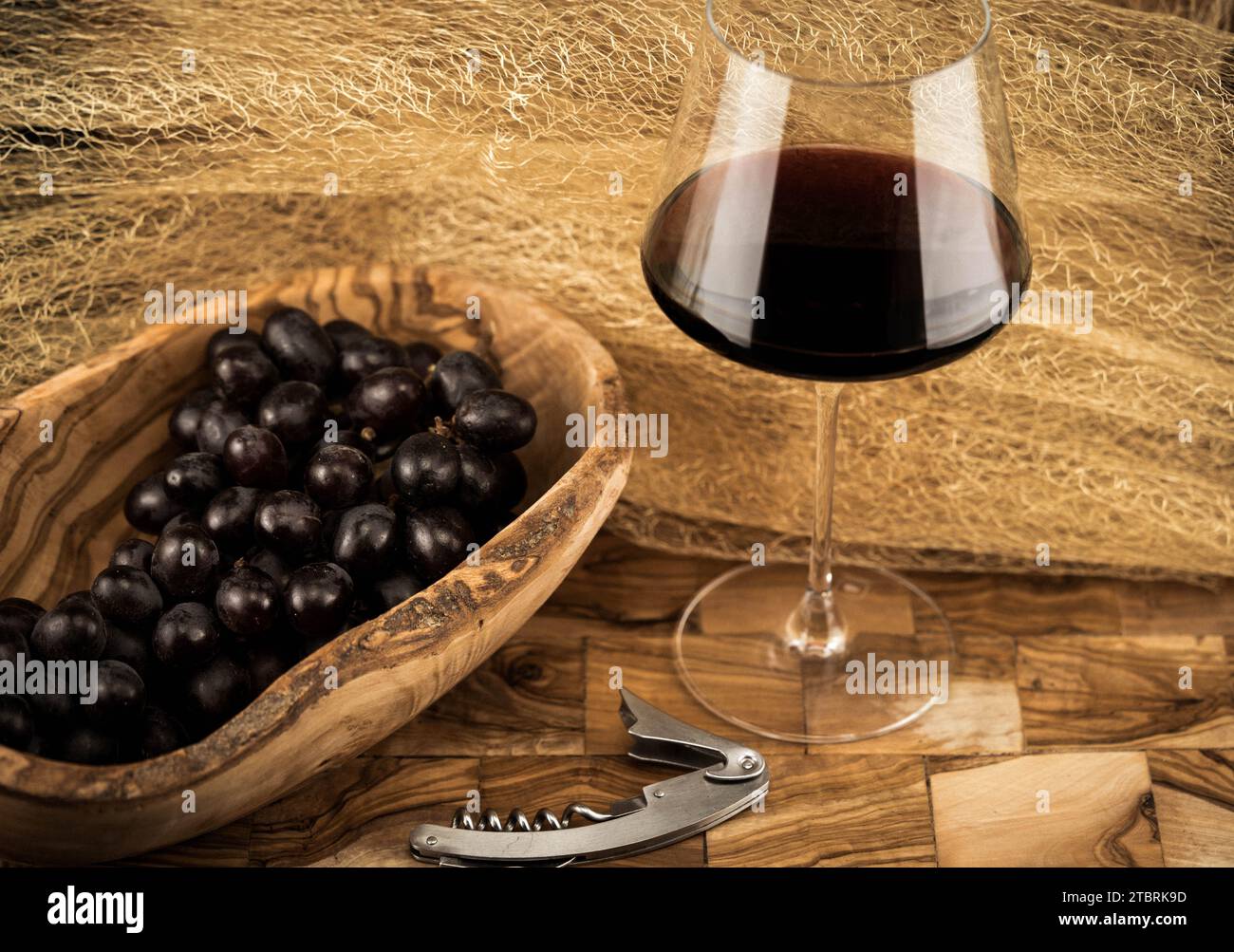 wine grapes and redwing on olive wood Stock Photo