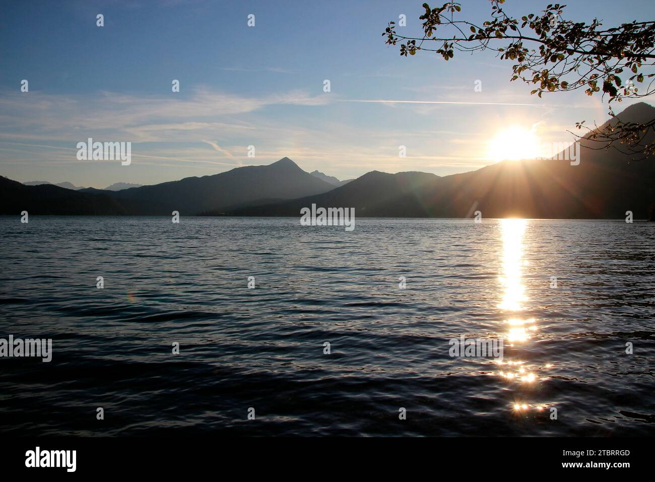 Evening mood sunset Walchensee in the Bavarian Alps, view to the Zugspitze, cloudy mood setting sun. Stock Photo