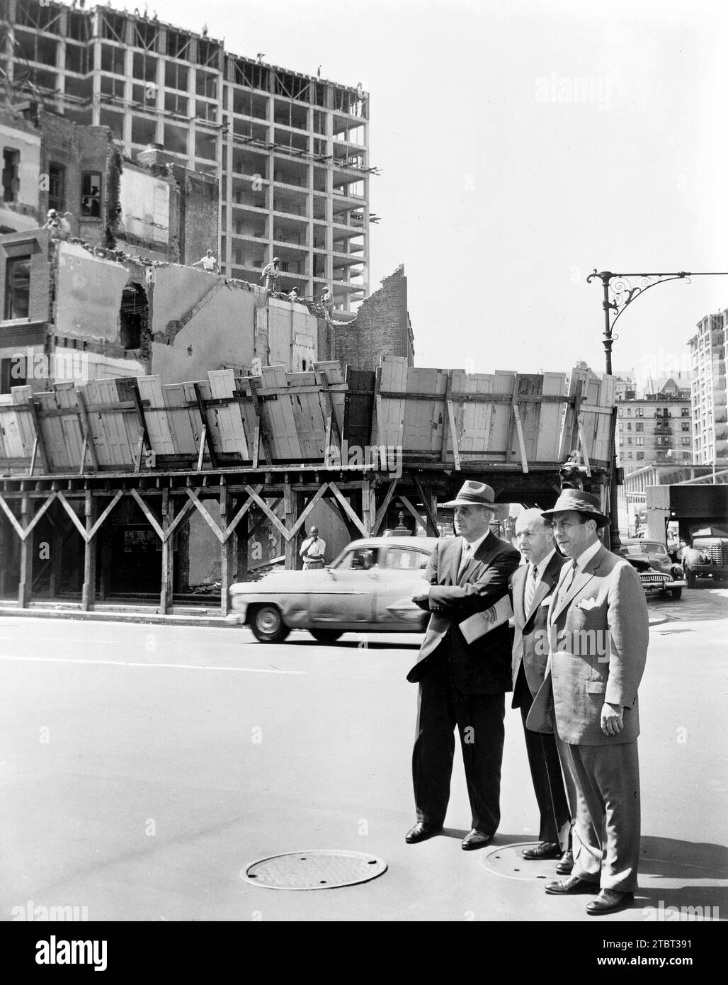 New York City mayor Robert Wagner (right) with Robert Moses (left) and Frank Meistrell (center), on housing project tour, 125th Street and Amsterdam Avenue, Harlem, New York City, New York, USA, Walter Albertin, New York World-Telegram and the Sun Newspaper Photograph Collection, August 9, 1956 Stock Photo