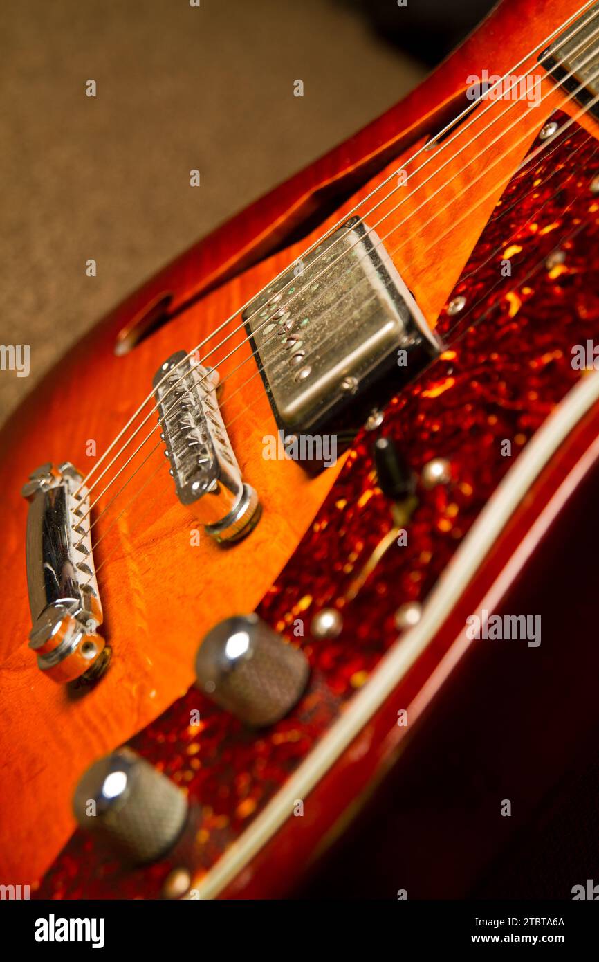 Sunburst Electric Guitar Detail in Warm Indoor Lighting with Glittery Edge Stock Photo