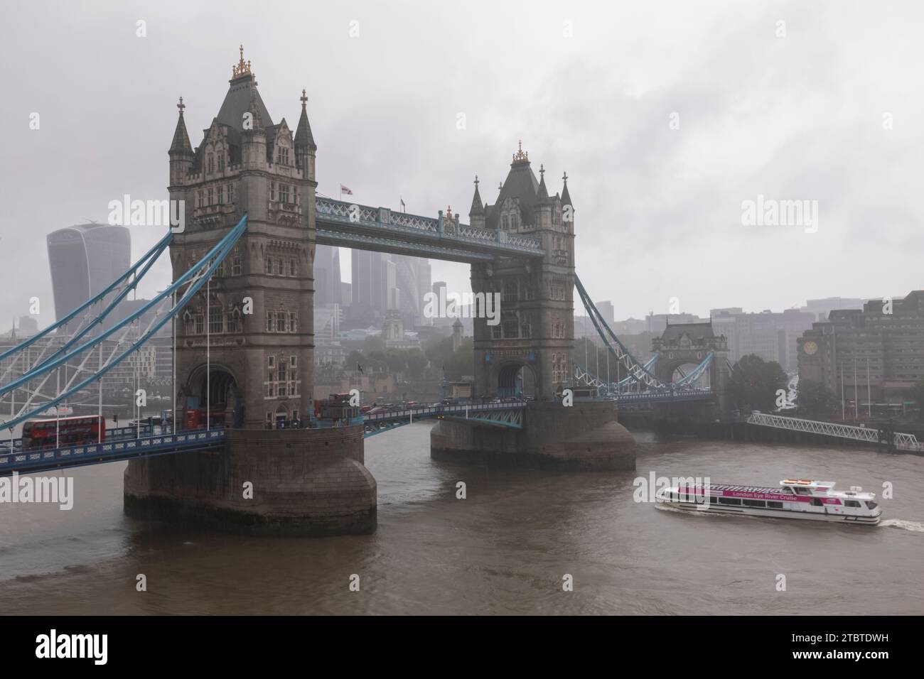 England, London, Tower Bridge and The City of London Skyline with River Thames in Wet Weather Stock Photo