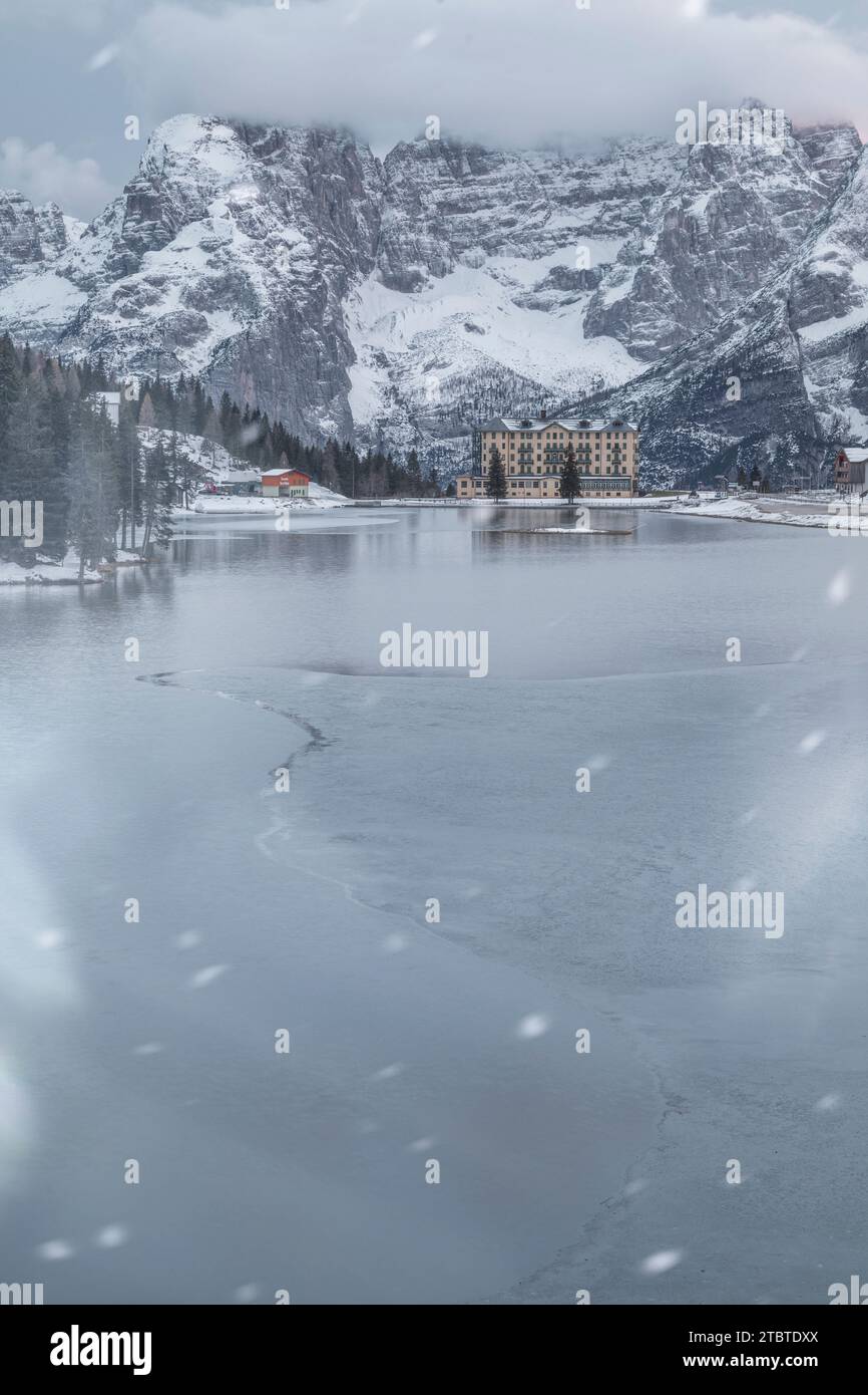 Italy, Veneto, province of Belluno, Auronzo di Cadore, snowstorm in Misurina with the frozen lake and mount Sorapis in background, Dolomites Stock Photo
