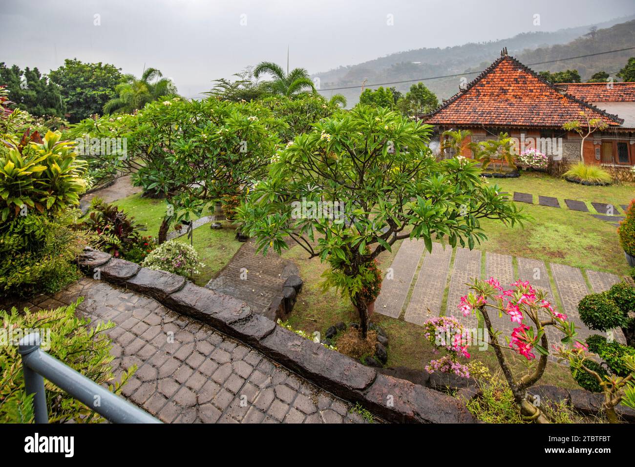 A Buddhist temple in the evening in the rain, the Brahmavihara-Arama temple has beautiful gardens and is also home to a monastery, tropical plants near Banjar, Bali Stock Photo